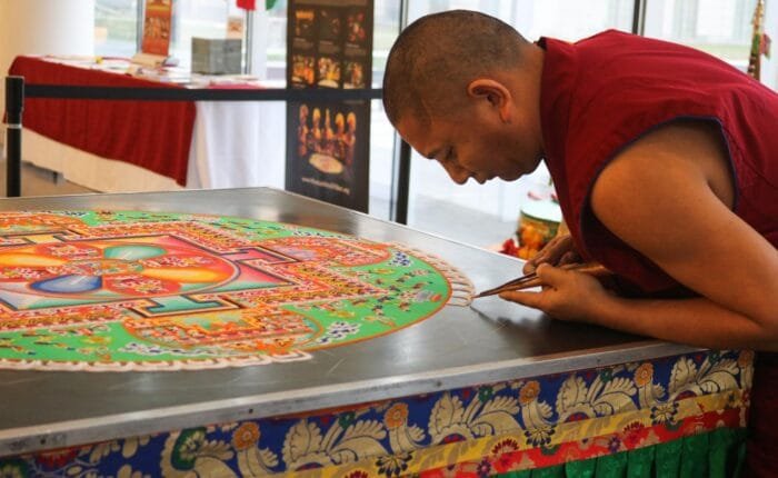 monk preparing mandala