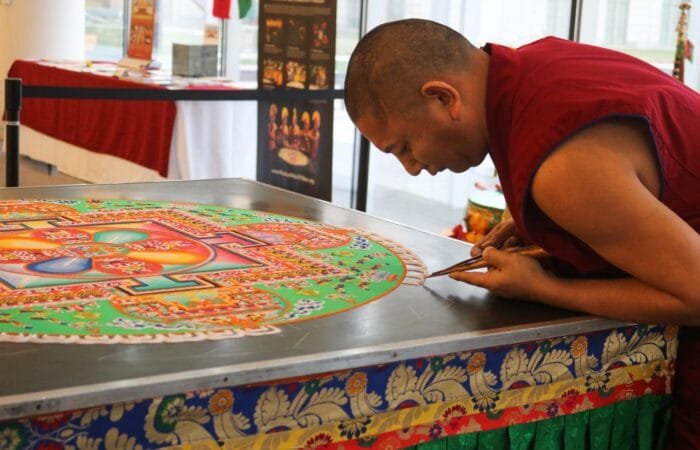 monk preparing mandala