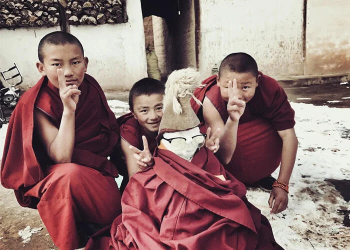 Tibetan monk kid playing Tibetan monk kid playing